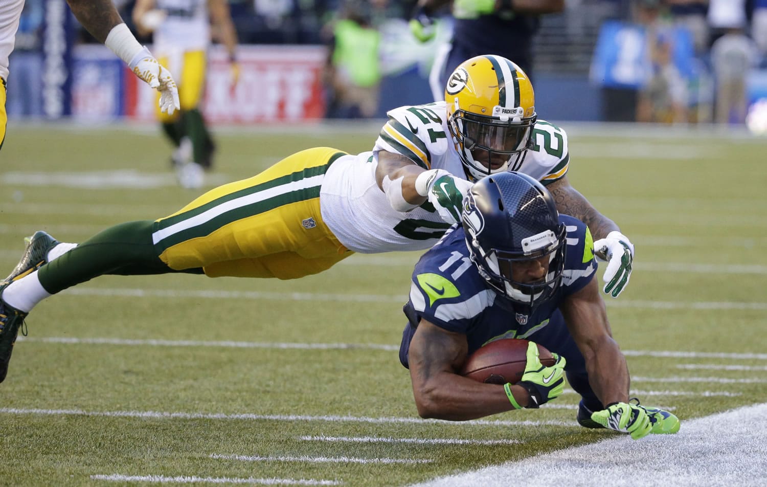 Green Bay Packers free safety Ha Ha Clinton-Dix (21) tackles Seattle Seahawks wide receiver Percy Harvin (11) after a pass reception during the first half of an NFL football game, Thursday, Sept. 4, 2014, in Seattle.