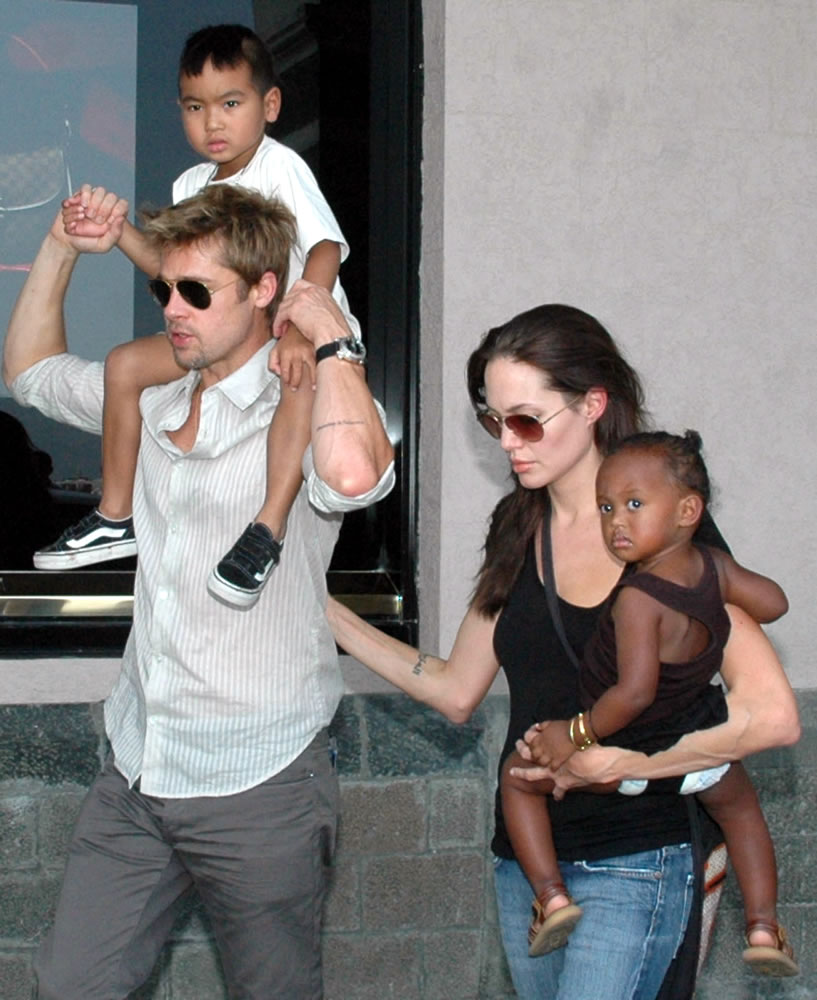 American movie star and United Nations High Commissioner for Refugees Ambassador Angelina Jolie, right, with her daughter, Zahara, and Brad Pitt, left, with Jolie's son, Maddox, walk near the Gateway of India in Mumbai, India.