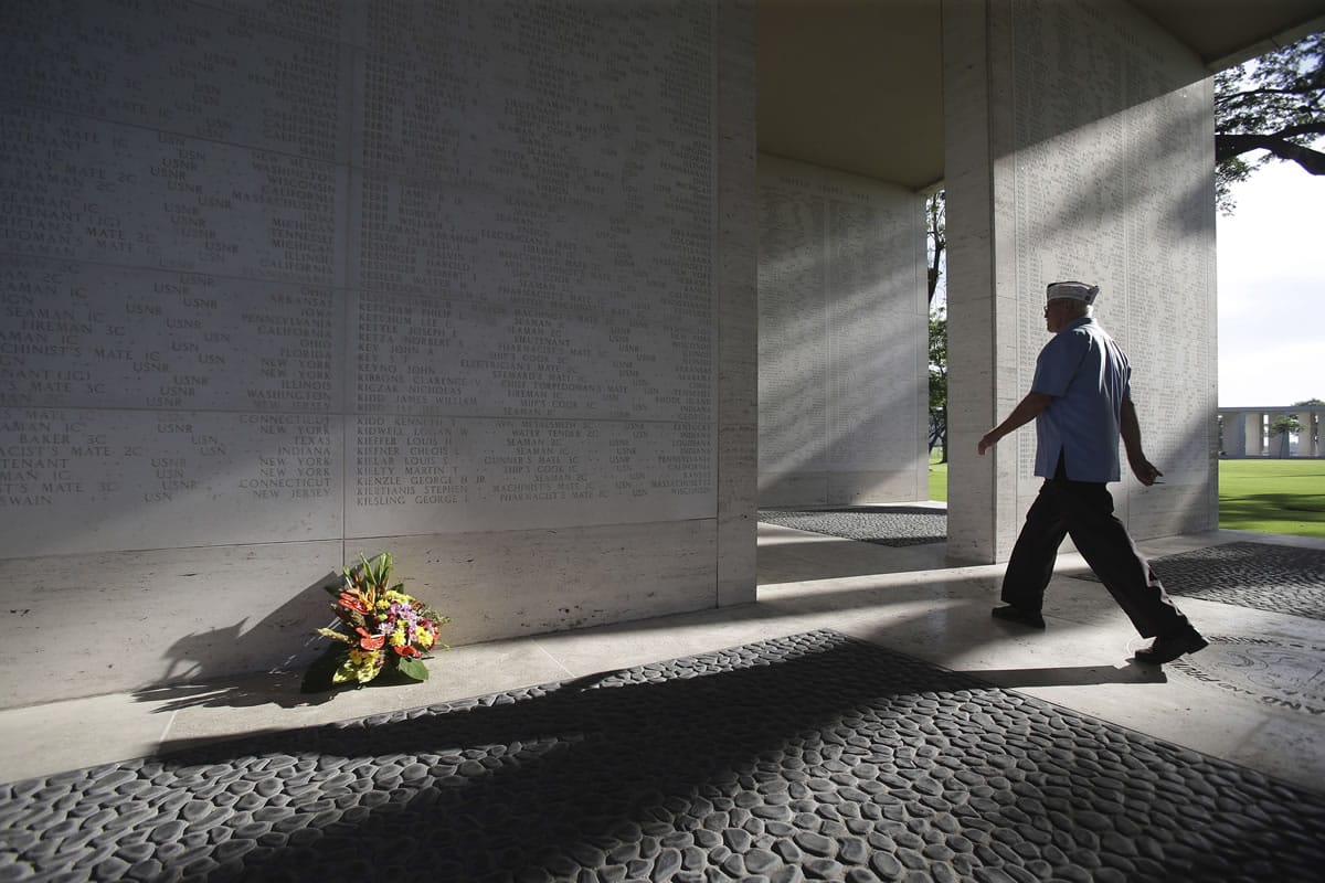 An American veteran passes Sunday by marble walls engraved with names of fallen U.S. soldiers as they attend U.S. Memorial Day ceremonies at the Manila American Cemetery and Memorial in suburban Taguig, south of Manila, Philippines. The cemetery site contains the largest number of graves of U.S.