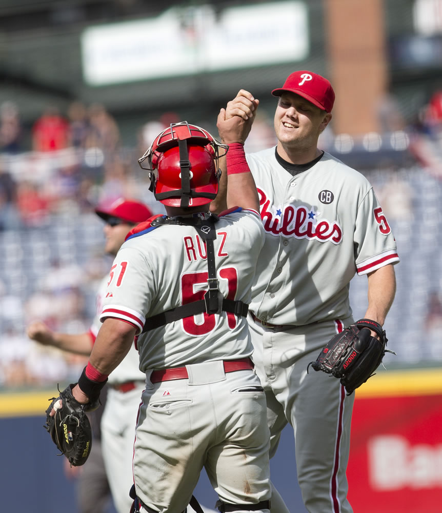 Philadelphia Phillies relief pitcher Jonathan Papelbon (58) celebrates with catcher Carlos Ruiz (51) after getting the final out in the ninth inning of a baseball game against the Atlanta Braves Monday, Sept. 1, 2014, in Atlanta. Papelbon combined with Cole Hamels, Ken Giles, and Jake Diekman for a no hitter.