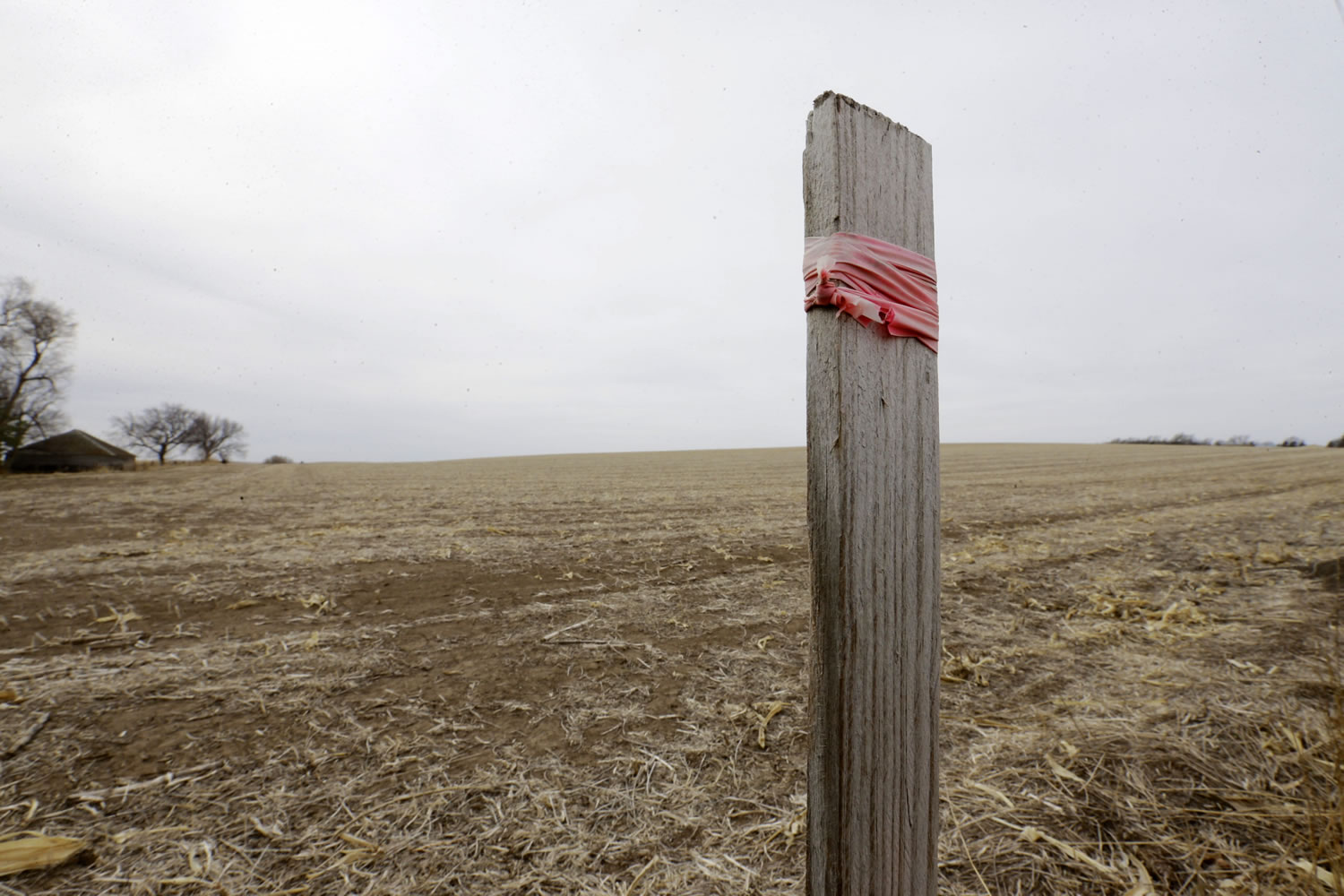 A stake in the ground wrapped with tape marks the route of the Keystone XL pipeline in Tilden, Neb.