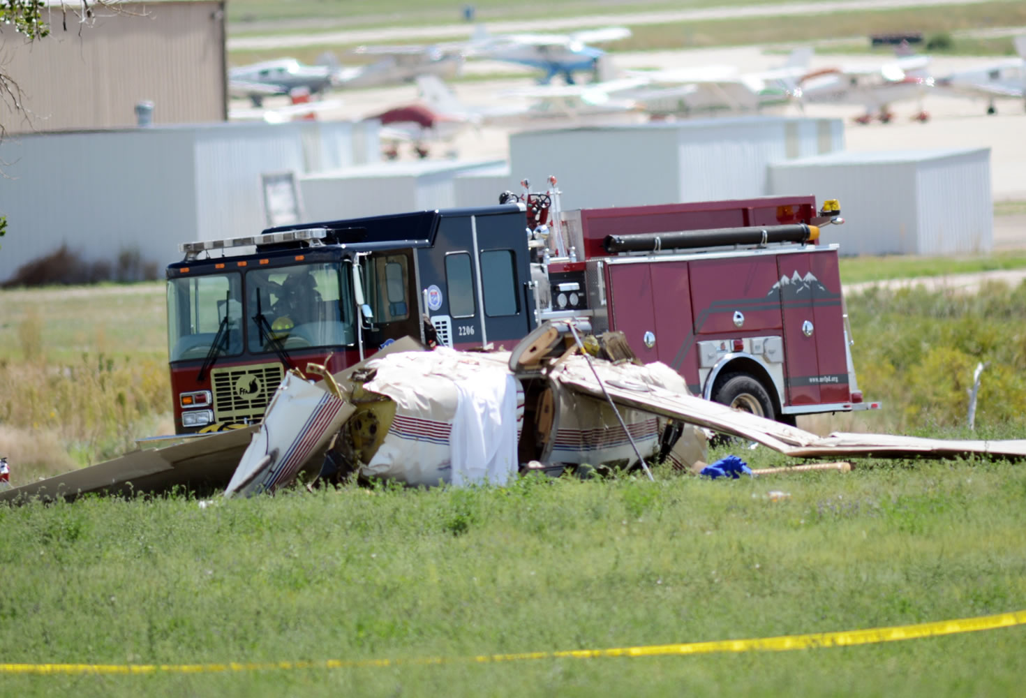 Firefighters work on the scene where three people were killed and two others injured after an airplane crashed in a field northwest of the main runway at Erie Municipal Airport while coming in for a landing in Erie, Colo., on Sunday.
