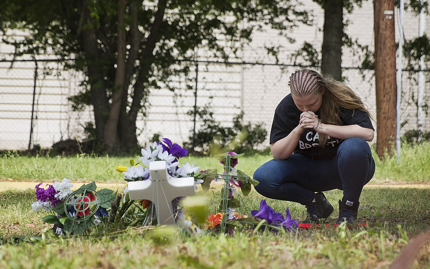 Asia Cromwell of Charleston S.C., visits a makeshift memorial at the scene where Walter Scott was killed by a North Charleston police officer Saturday after a traffic stop in North Charleston, S.C., on Friday.