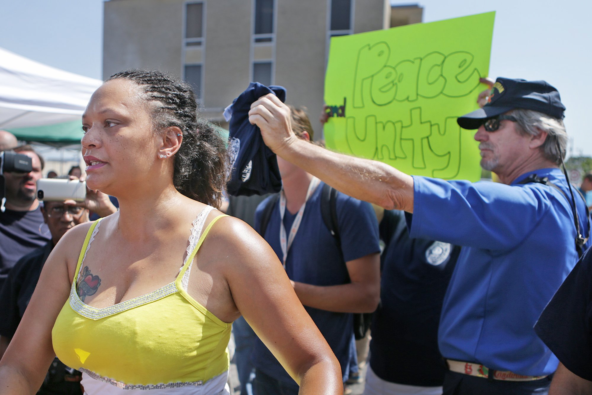 Sondra Fifer, of St. Louis, voices her disagreement with the rally for Ferguson police Officer Darren Wilson on Saturday, Aug. 23, 2014, at Barney's Sports Pub in St. Louis. &quot;I'm not against officers, I'm against police brutality,&quot; Fifer said. Ferguson's streets remained peaceful as tensions between police and protesters continued to subside after nights of violence and unrest that erupted when Wilson, a white police officer, fatally shot Michael Brown, an unarmed black 18-year-old. (AP Photo/St.