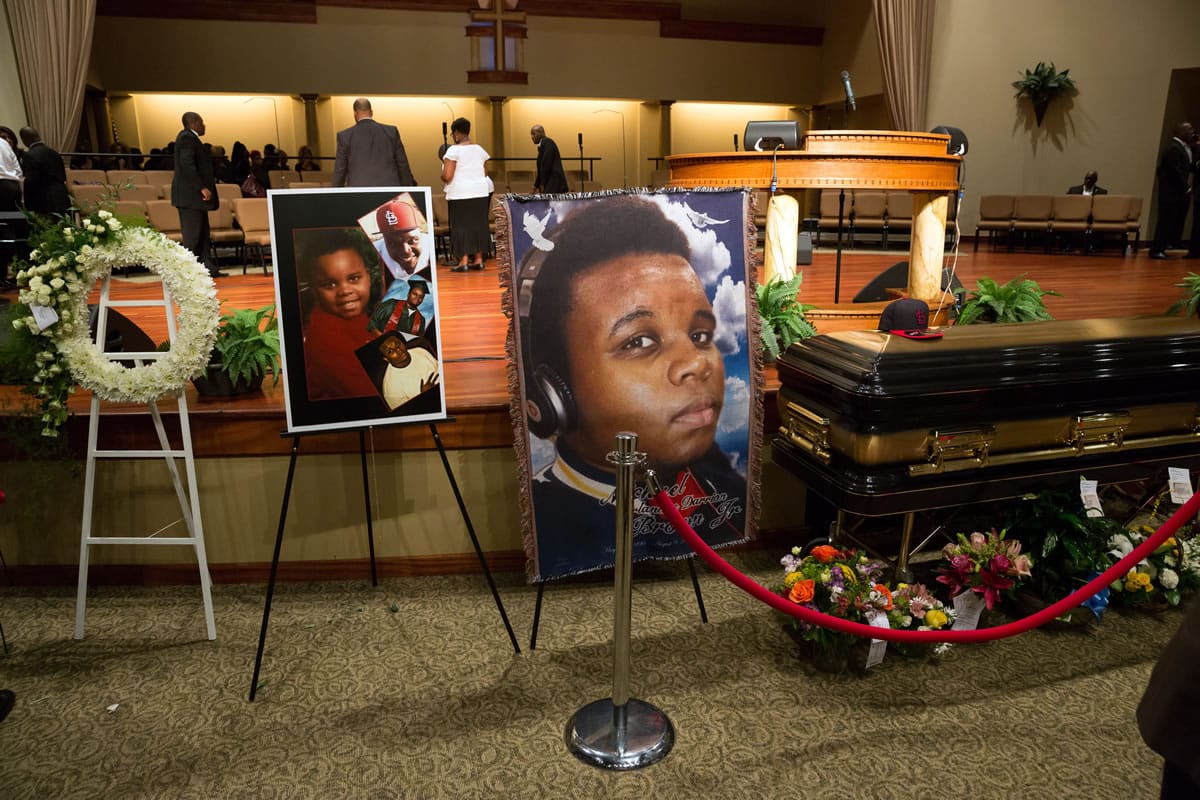 Photos surround the casket of Michael Brown before the start of his funeral at Friendly Temple Missionary Baptist Church in St.