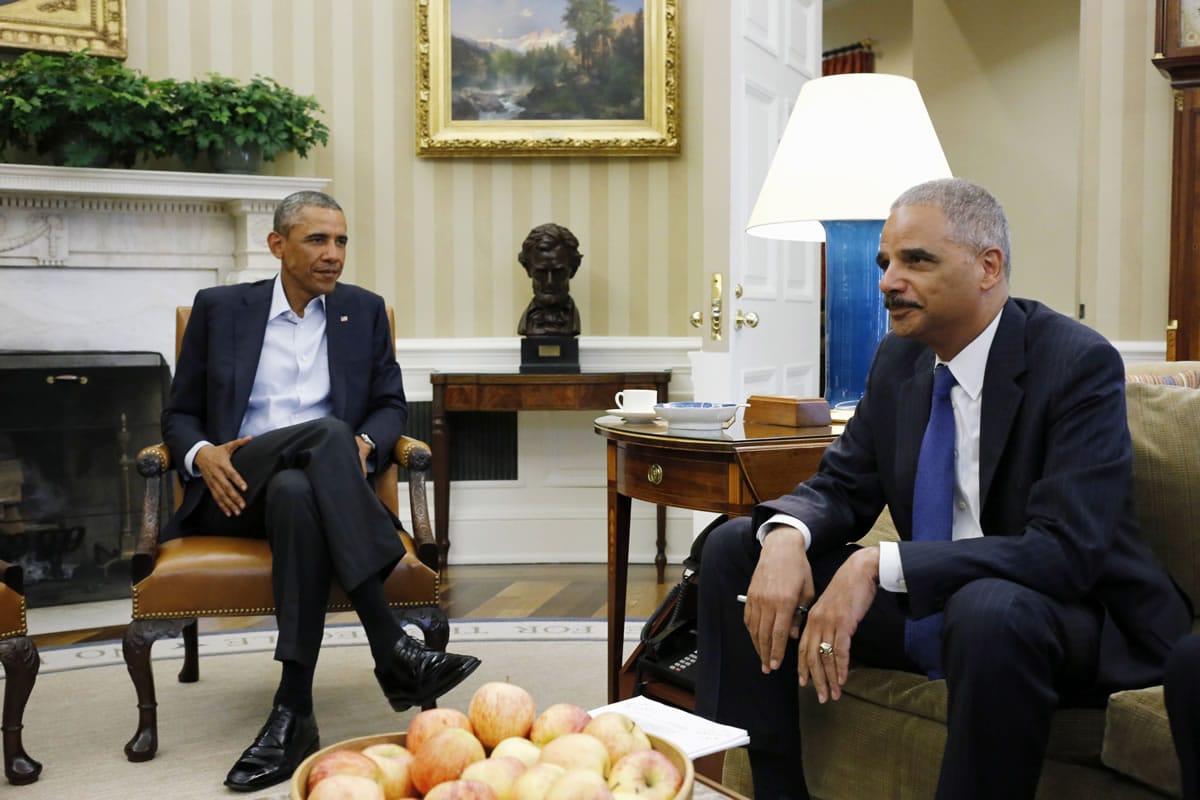 President Barack Obama meets Monday with Attorney General Eric Holder in the Oval Office of the White House in Washington. Holder, who is leading the federal response to the racial turmoil in Ferguson, Mo., talks about the nation's civil rights struggles in a way none of the 81 previous U.S.