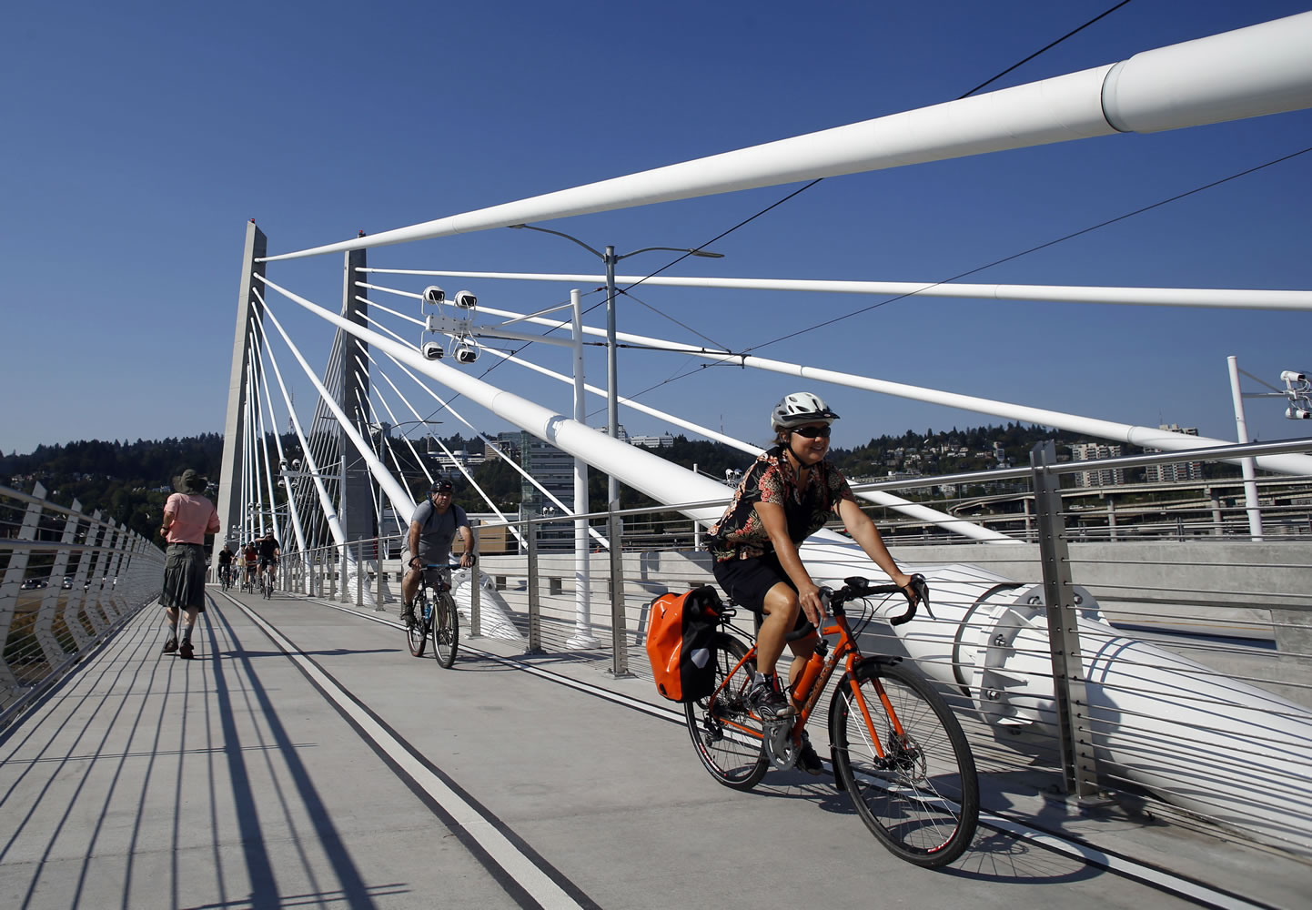 Runners and cyclists make their away across the newly opened Tilikum Crossing, a unique bridge, in Portland on Saturday.