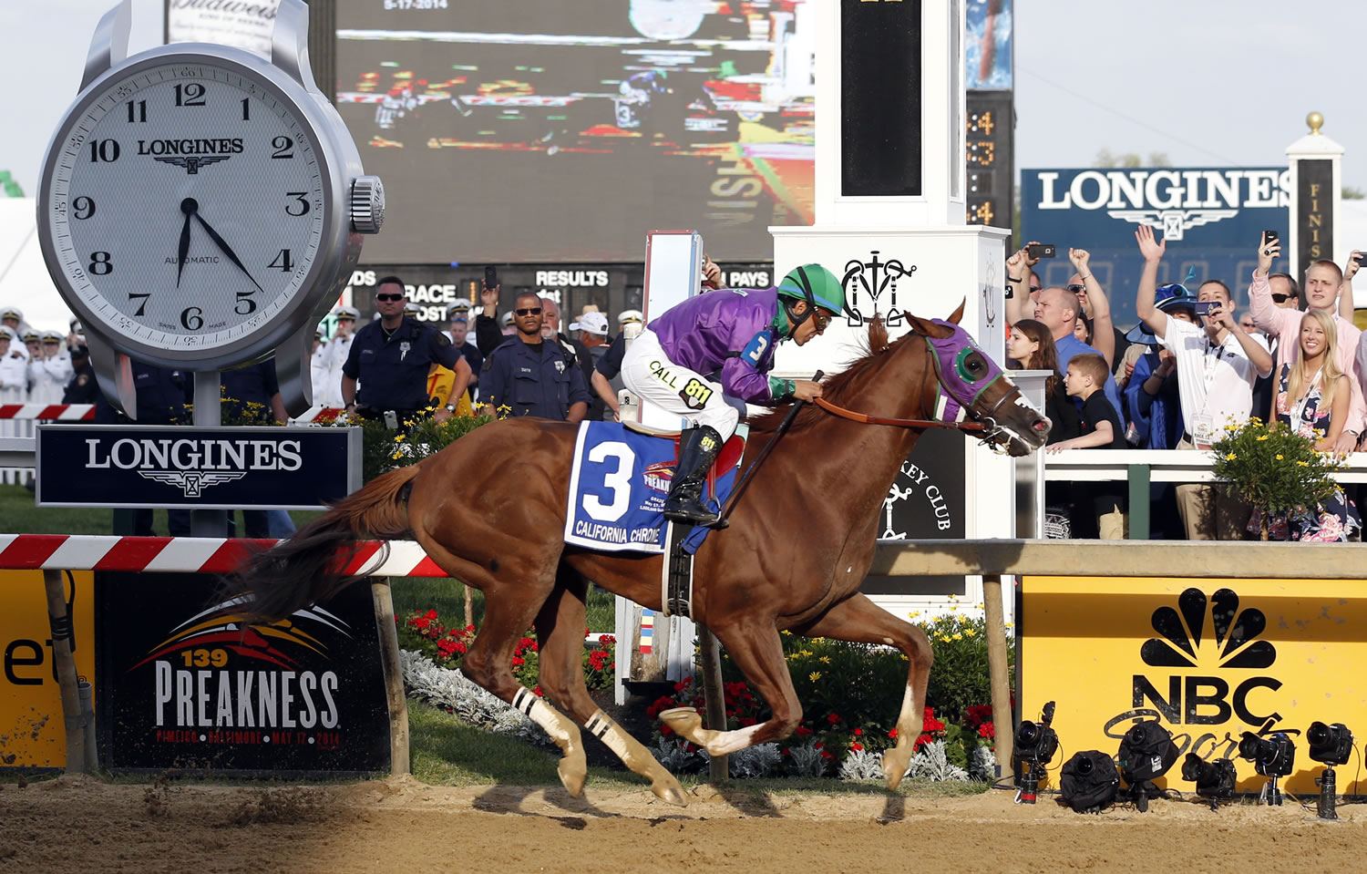California Chrome, ridden by jockey Victor Espinoza, wins the 139th Preakness Stakes horse race at Pimlico Race Course, Saturday, May 17, 2014, in Baltimore.