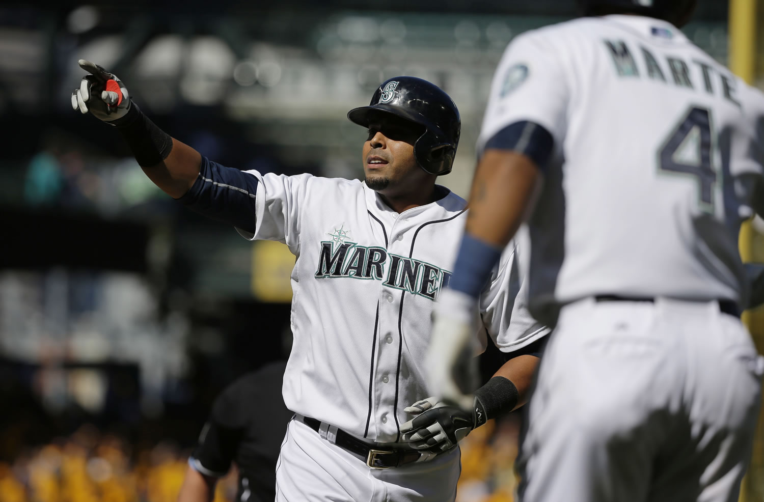 Seattle Mariners' Nelson Cruz reacts as he reaches home plate after hitting a two-run home run that also scored Ketel Marte (4) in the seventh inning of a baseball game against the Texas Rangers, Thursday, Sept. 10, 2015, in Seattle. The Mariners won 5-0. (AP Photo/Ted S.