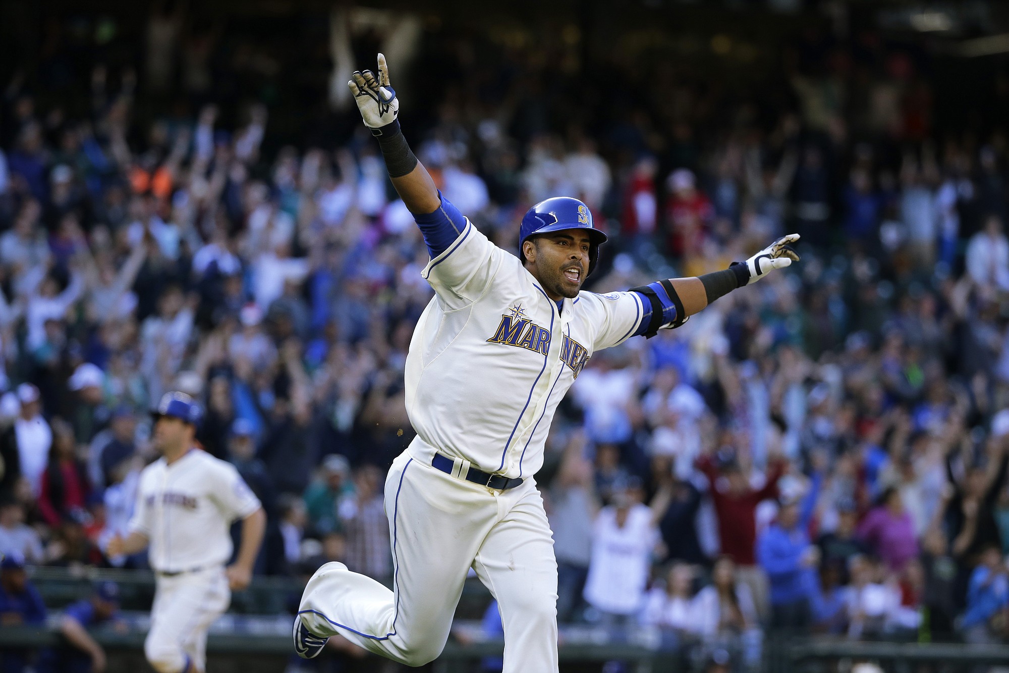 Seattle Mariners' Nelson Cruz celebrates after he hit a walk-off RBI single in the ninth inning to score Seth Smith and give the Mariners a 11-10 win over the Texas Rangers, on Sunday, April 19, 2015, in Seattle. (AP Photo/Ted S.