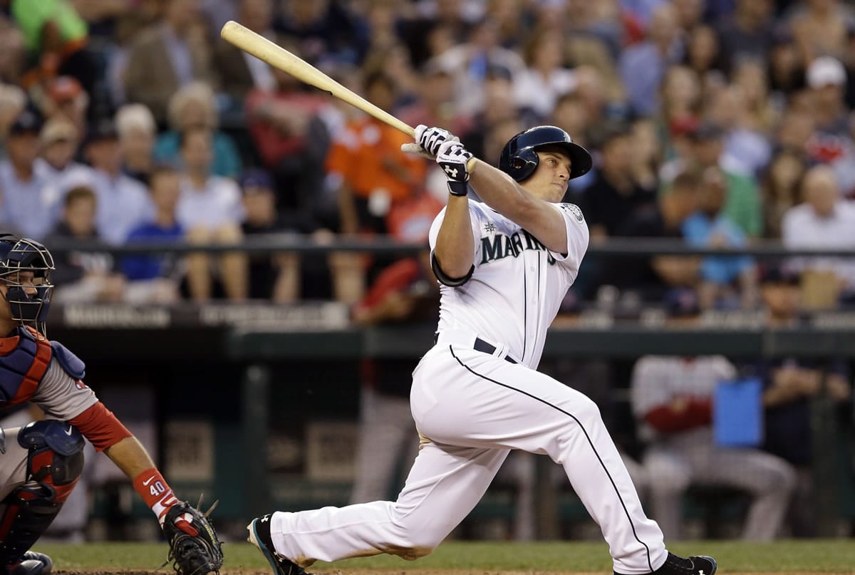 Seattle Mariners' Kyle Seager watches his three-run home run in front of Boston Red Sox catcher A.J. Pierzynski during the fourth inning of a baseball game Tuesday, June 24, 2014, in Seattle.