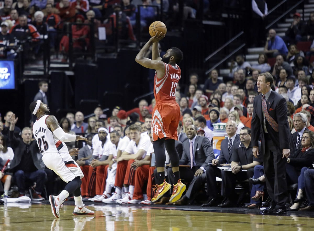 Houston guard James Harden puts up a 3-point shot over Portland's Mo Williams (25) as Trail Blazers coach Terry Stotts watches at right during the second half of Game 3 on Friday. Harden scored 37 points as the Rockets won in overtime 121-116.