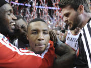 Portland Trail Blazers' Damian Lillard, center, celebrates his winning shot against the Houston Rockets on Friday.