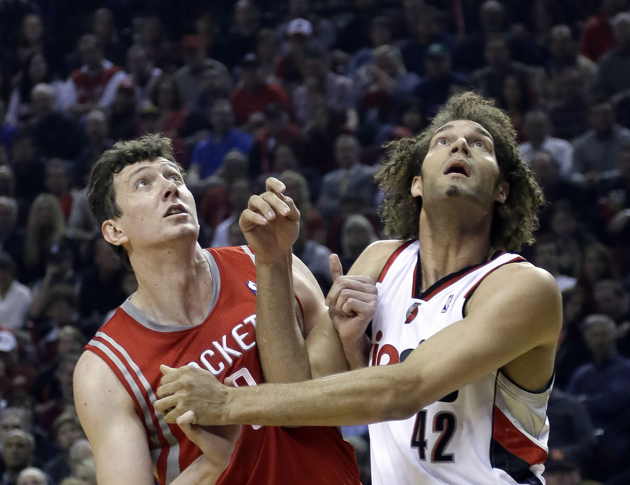 Houston Rockets center Omer Asik, left, and Portland Trail Blazers center Robin Lopez jockey for position on a free throw during the first half of Game 3 of an NBA basketball first-round playoff series in Portland, Ore., Friday, April 25, 2014.