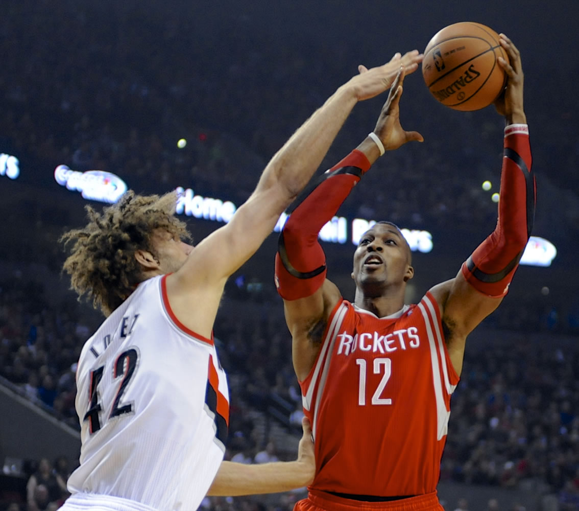 Houston Rockets' Dwight Howard (12) shoots against Portland Trail Blazers' Robin Lopez (42) during the first half of Game 4 Sunday.