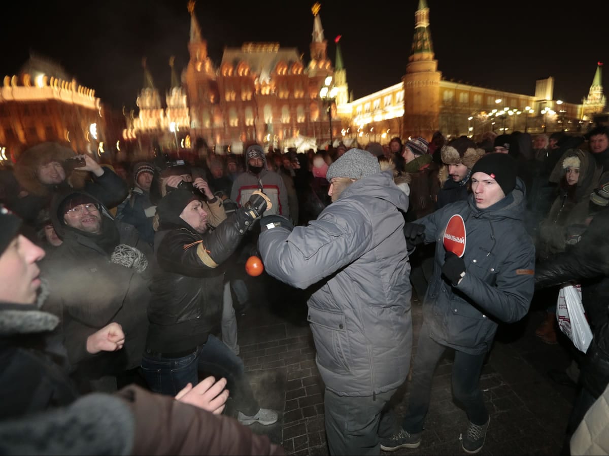 Supporters and opponents of Russian opposition activist and anti-corruption crusader Alexei Navalny fight each other during unsanctioned protest Tuesday in Manezhnaya Square in Moscow, Russia. The unsanctioned protest came hours after Alexei Navalny was found guilty of fraud and given a suspended sentence.