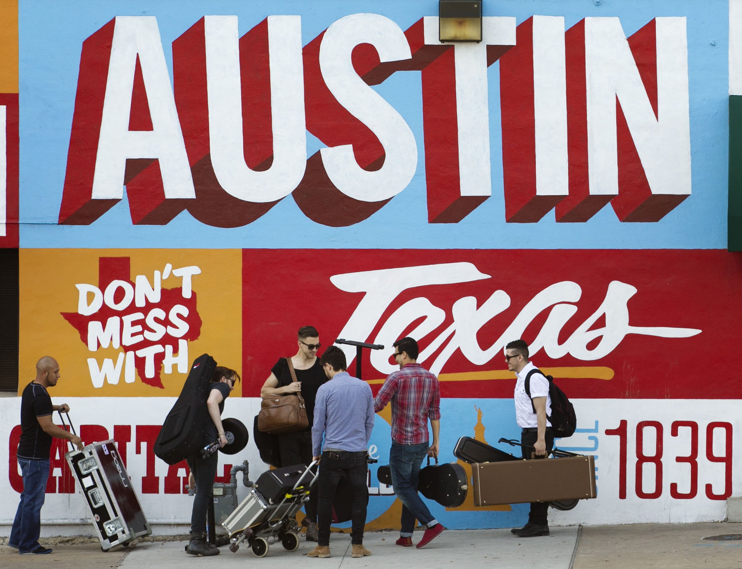 A band is on the move on the corner of Sixth Street and I-35 at South by Southwest in Austin, Texas in 2013.