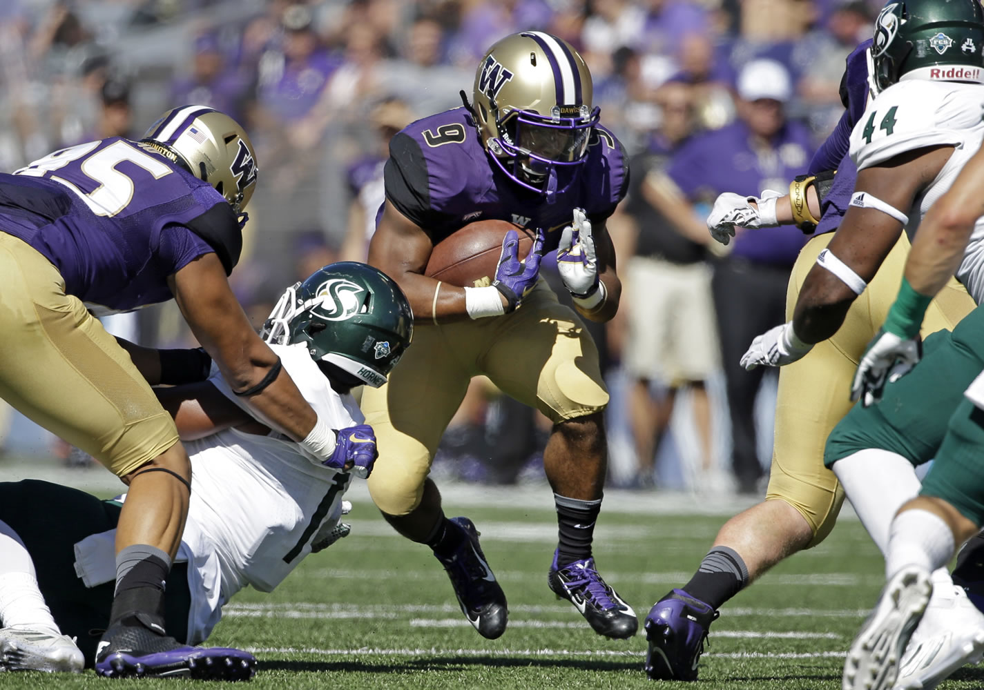 Washington's Myles Gaskin (9) tries to break through a hole on a run against Sacramento State in the first half of an NCAA college football game Saturday, Sept. 12, 2015, in Seattle.