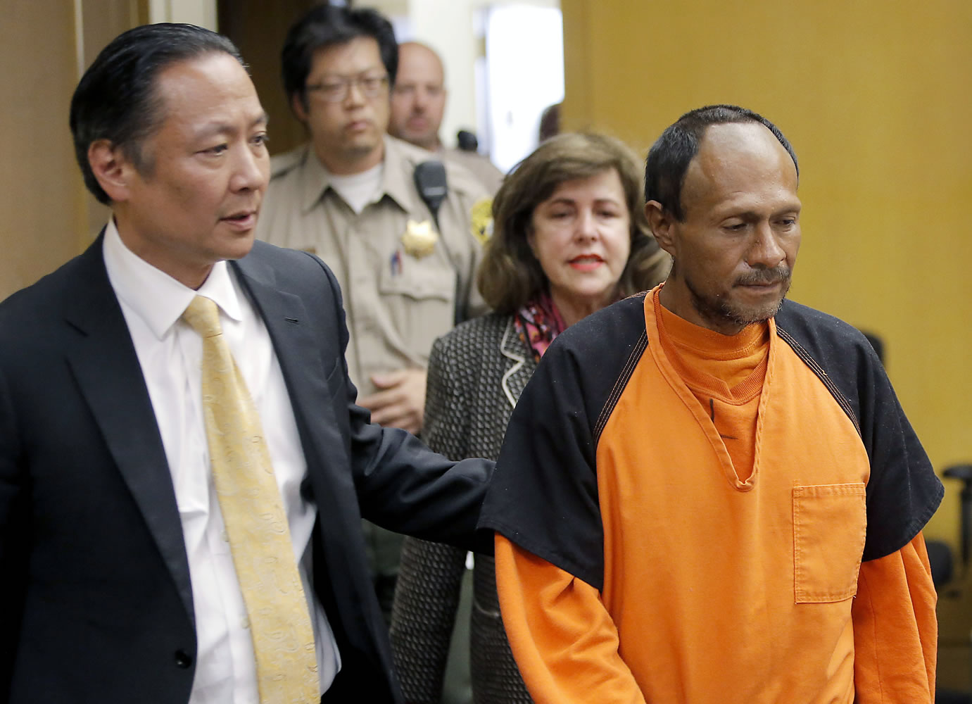 Juan Francisco Lopez-Sanchez, right, is lead into the courtroom July 7 by San Francisco Public Defender Jeff Adachi, left, and Assistant District Attorney Diana Garciaor, center, for his arraignment at the Hall of Justice in San Francisco. The parents of Kathryn Steinle filed a wrongful death claim Tuesday, Sept. 1, 2015 alleging that the San Francisco Sheriff's Department is to blame for releasing an illegal immigrant from jail despite a federal &quot;detainer&quot; request to keep in custody for possible deportation proceedings. A claim is usually a precursor to a lawsuit.