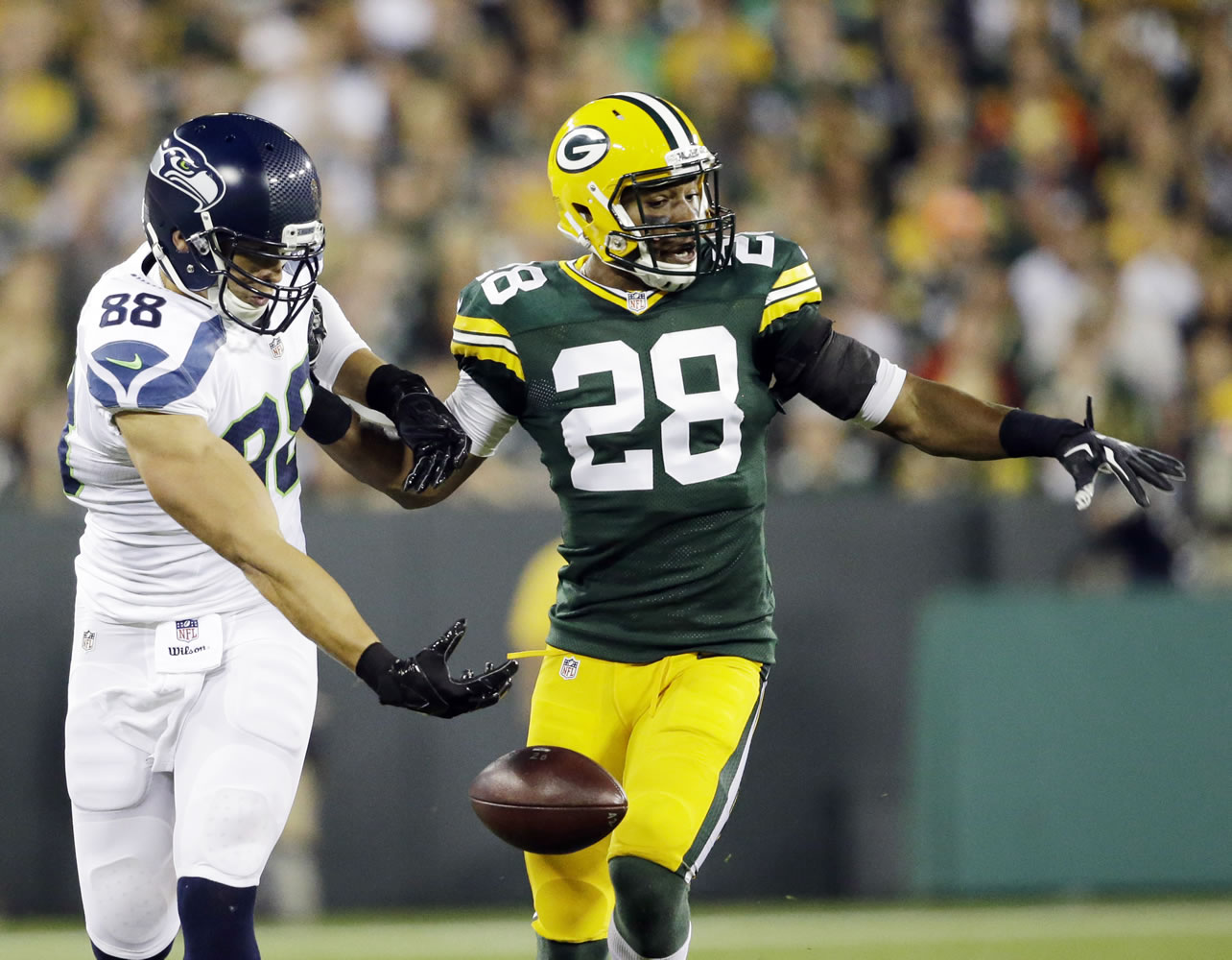Green Bay Packers' Sean Richardson (28) breaks up a pass intended for Seattle Seahawks' Jimmy Graham during the first half Sunday, Sept. 20, 2015, in Green Bay, Wis.