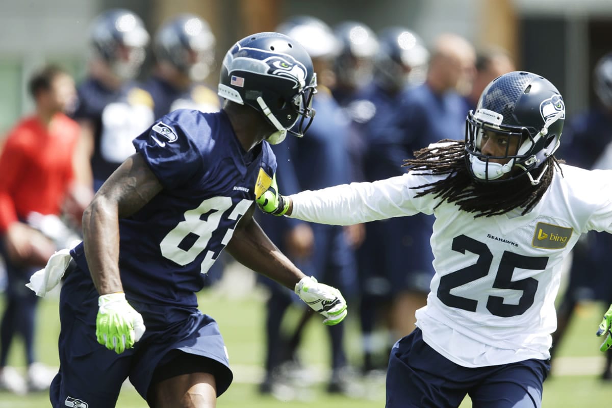 Seattle Seahawks cornerback Richard Sherman, right, defends wide receiver Ricardo Lockette during organized team activity, Tuesday, in Renton.