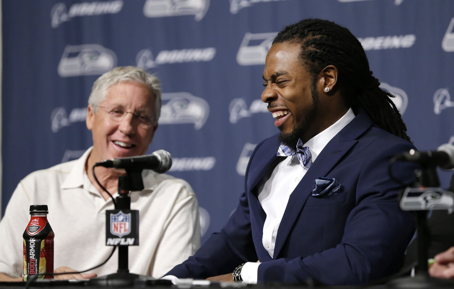 Seattle Seahawks' Richard Sherman, right, laughs during a news conference as he sits with head coach Pete Carroll Wednesday at the team's headquarters in Renton.