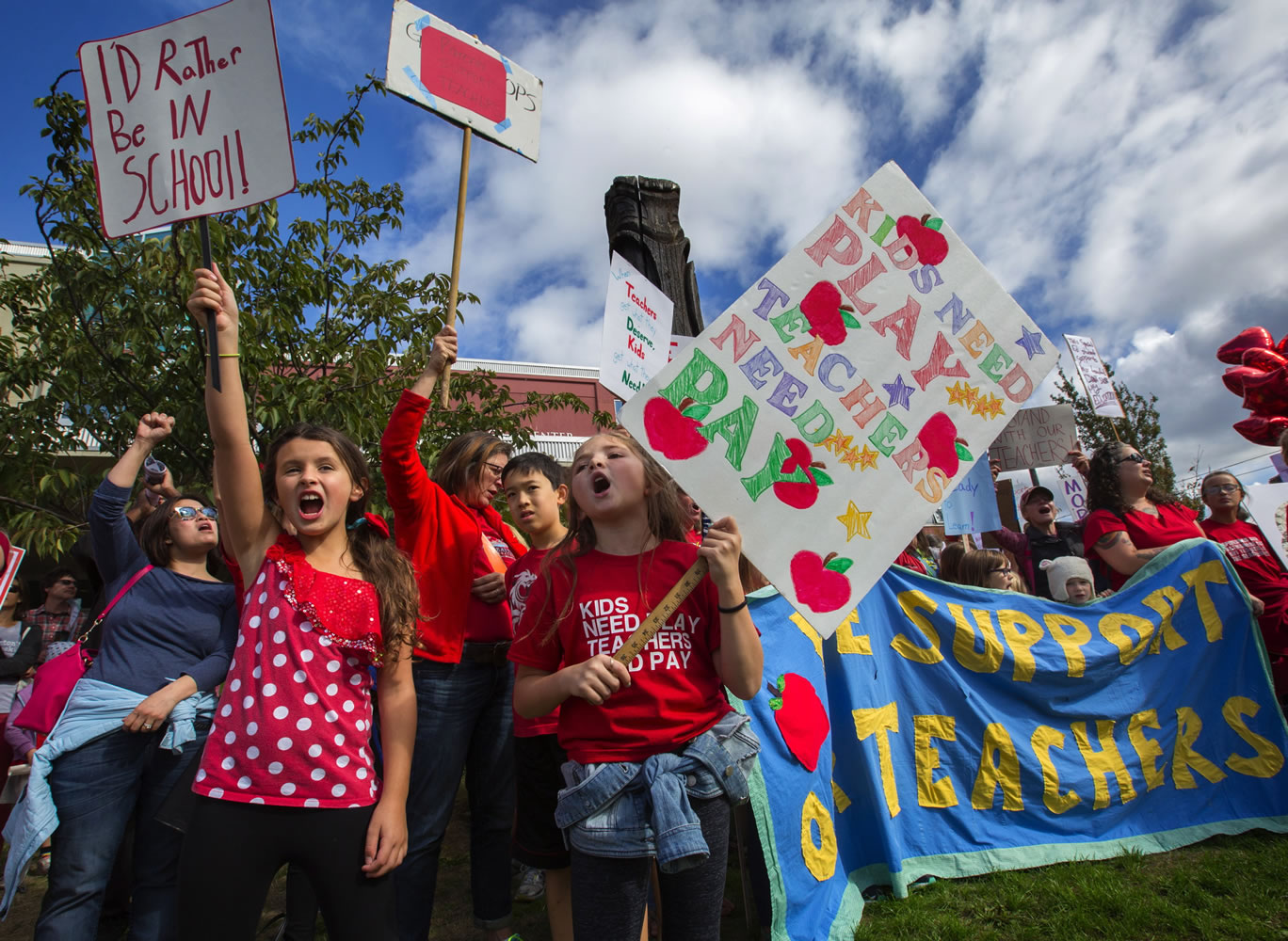 Sydney Stumpf, left, and Aderyn Kee, both students at Loyal Heights Elementary School, protest after marching with parents, students and supporters of teachers from Pioneer Square to the John Stanford Center on Tuesday in Seattle. Teachers who had been on the picket lines for a week will be back in the classroom today. (Ellen M.