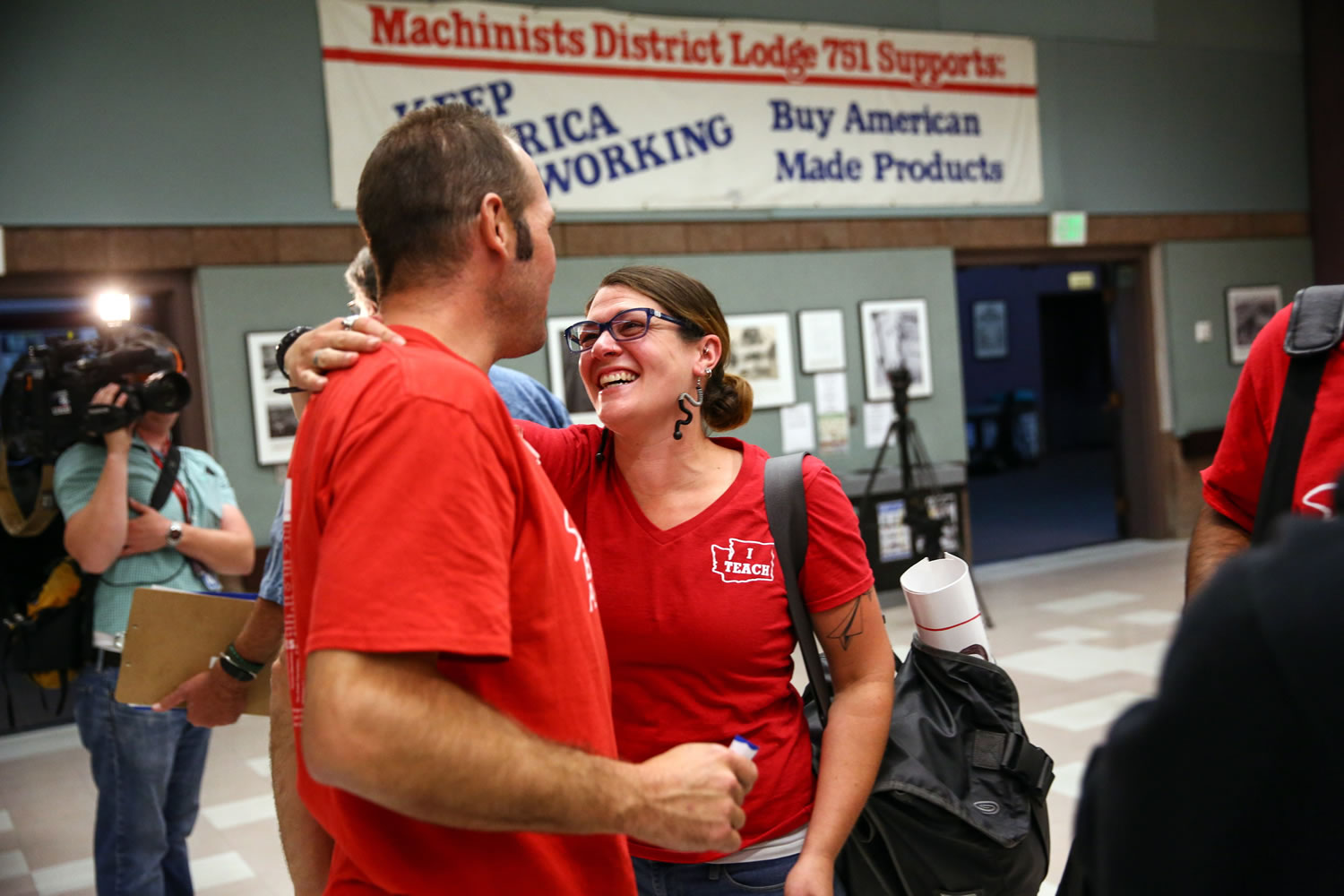 Union members embrace after Seattle Education Association leaders voted to suspend a strike Tuesday, Sept. 15, 2015, and bring a new contract for Seattle Public Schools educators to a vote on Sunday. The vote to suspend the strike was held at the Aerospace Machinists Union hall in Seattle.