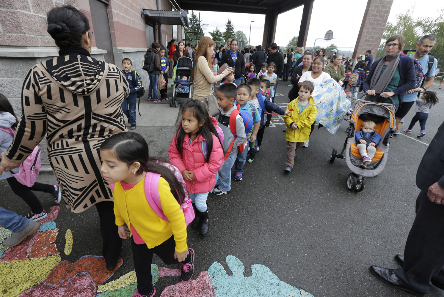 Students at walk to their classrooms on the first day of school at Concord International School, Thursday, Sept. 17, 2015, in Seattle. Thursday was the first day for students in the Seattle School District to begin classes for the new school year following a weeklong teachers strike. (AP Photo/Ted S.