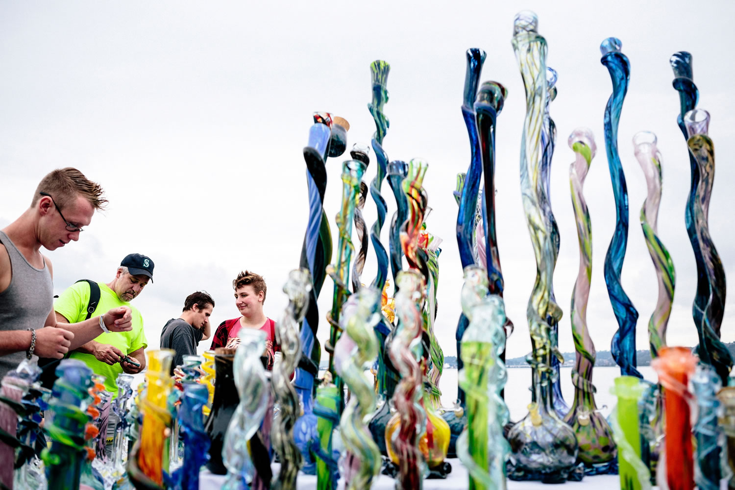 Attendees peruse a myriad of pipes, bongs and other smoking paraphernalia on the first of three days of Hempfest, Seattle's annual gathering to advocate the decriminalization of marijuana Friday at Myrtle Edwards Park on the Seattle waterfront in Seattle, Washington.