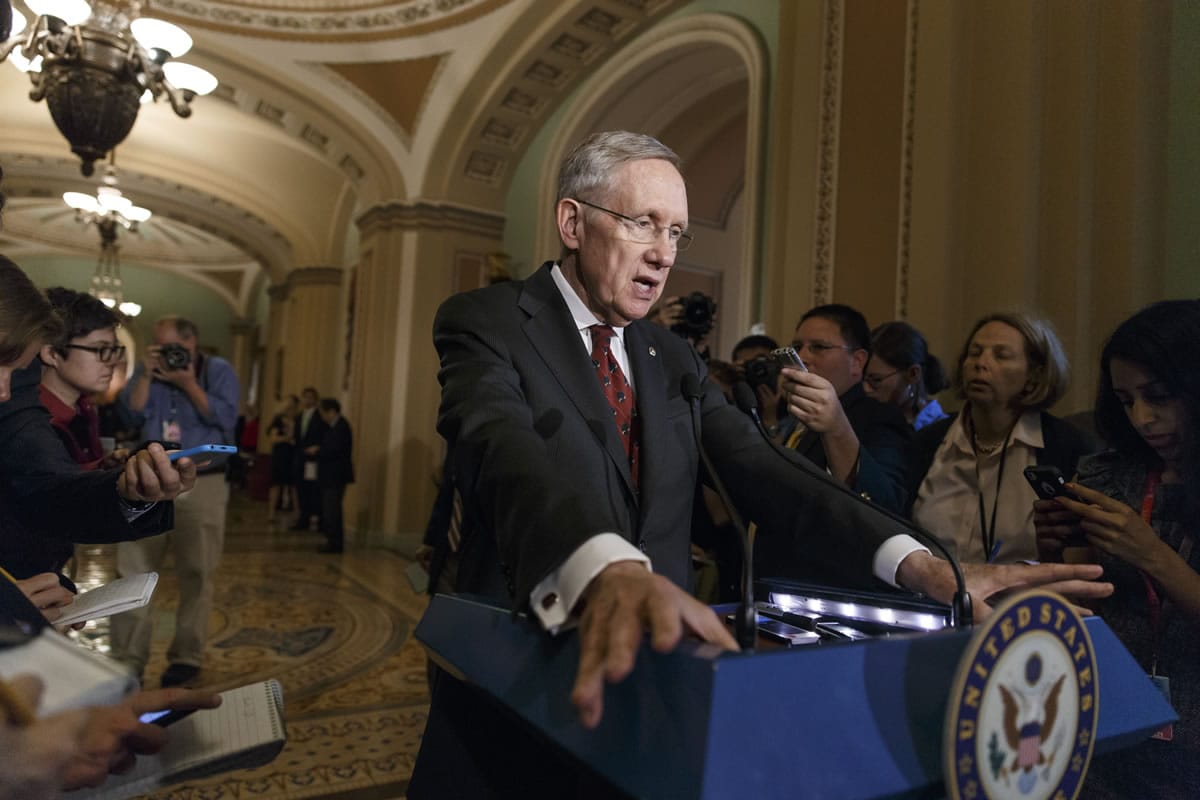 Senate Majority Leader Harry Reid, D-Nev., talks to reporters as Congress returns from a two week recess, at the Capitol in Washington on Tuesday.