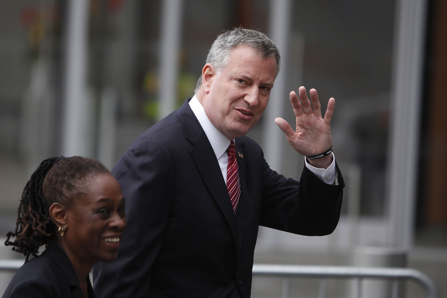 New York City Mayor Bill de Blasio waves to onlookers as he and his wife, Chirlane McCray, depart following a ceremony dedicating the National September 11 Memorial Museum on May 15 in New York.