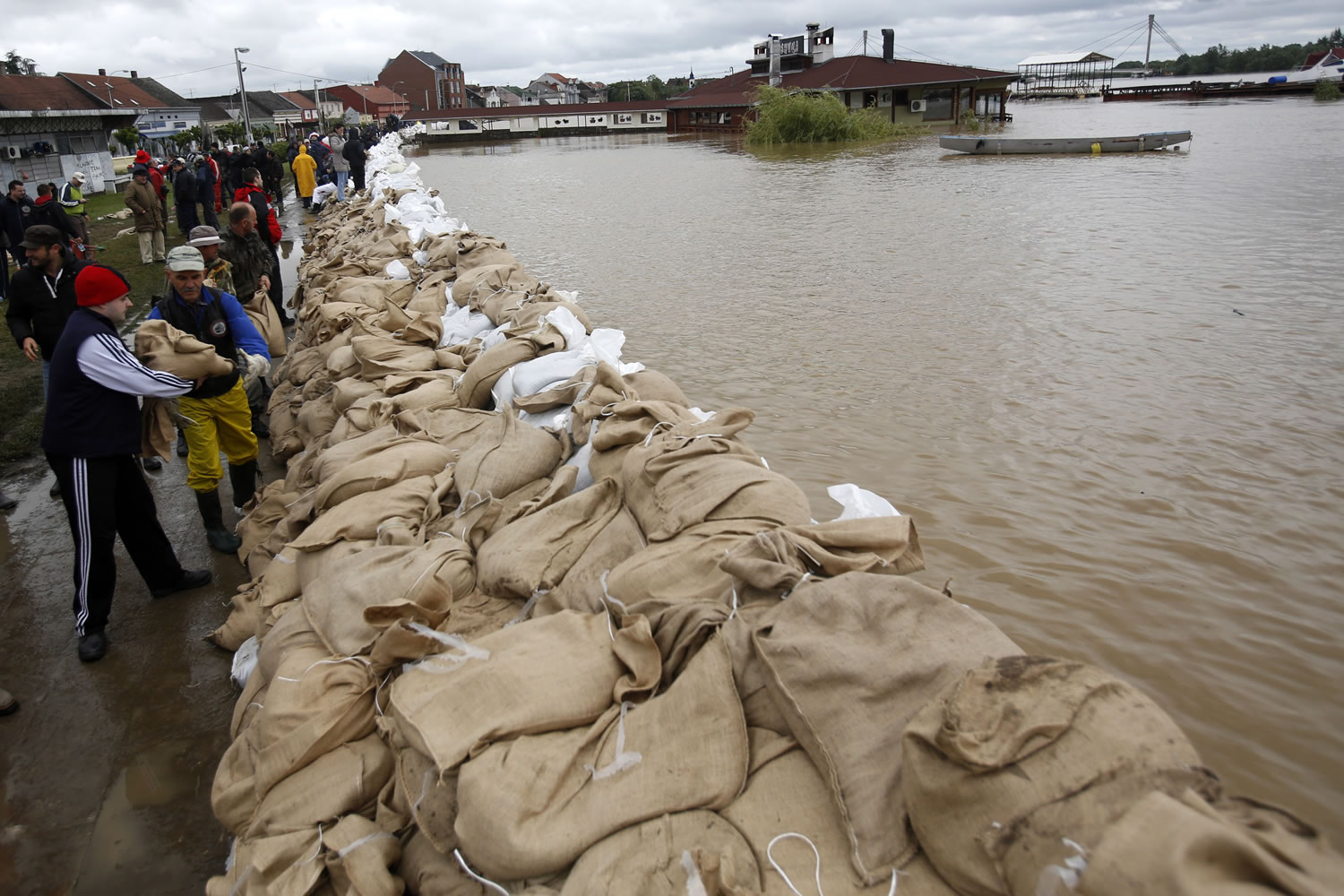 People pile sandbags by the bank of the Sava River on Saturday in Sremska Mitrovica, Serbia.