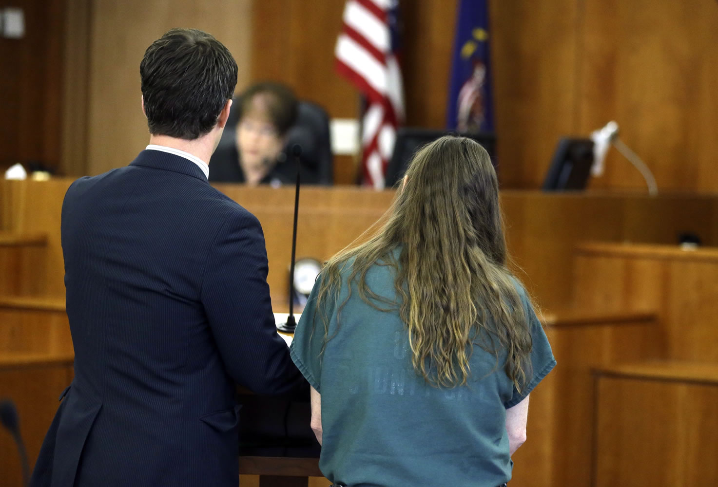 Megan Huntsman, right, who is accused of killing six of her babies and storing their bodies in her garage, appears in court with Doug Thompson, one of her defense attorneys, Monday in Provo, Utah.
