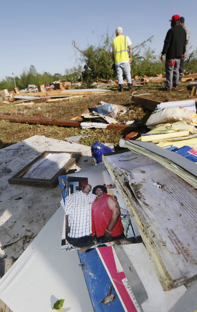 A photo of Ruth Bennett, right, a child care center owner who was killed at her facility in Monday's tornado, dries outside the remains of the building Tuesday  in Louisville, Miss.