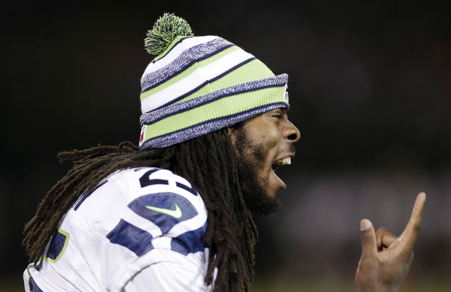 Seattle Seahawks cornerback Richard Sherman yells on the sideline during the second half of an NFL preseason football game against the Oakland Raiders in Oakland, Calif.