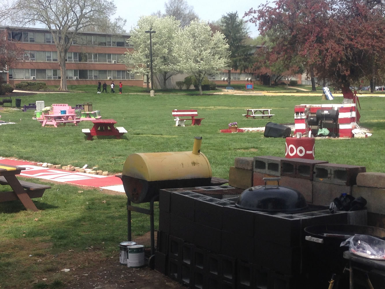 Delaware State University students on Sunday finish cleaning the area where three people were shot Saturday at a cookout on campus in Dover, Del.