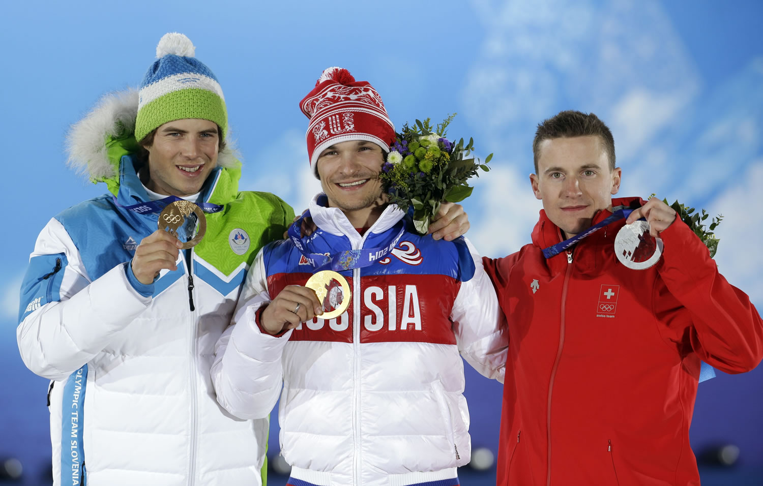 Men's snowboard parallel giant slalom medalists, from left, Slovenia's Zan Kosir, bronze, Russia's Vic Wild, gold, and Switzerland's Nevin Galmarini, silver, pose with their medals at the 2014 Winter Olympics in Sochi, Russia, Wednesday, Feb. 19, 2014.