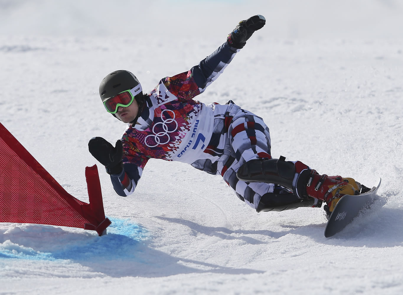 Russia's Vic Wild, a native of White Salmon, Wash., competes on the way to winning the men's snowboard parallel giant slalom semifinal at the Rosa Khutor Extreme Park on  Wednesday in Krasnaya Polyana, Russia.