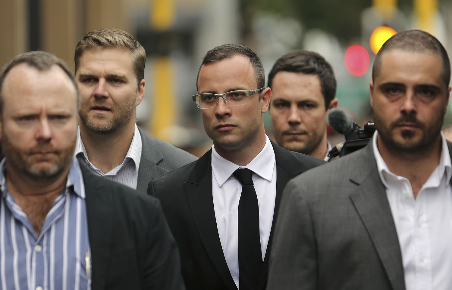 Oscar Pistorius, center, with his relatives, arrives Friday at the high court in Pretoria, South Africa.
