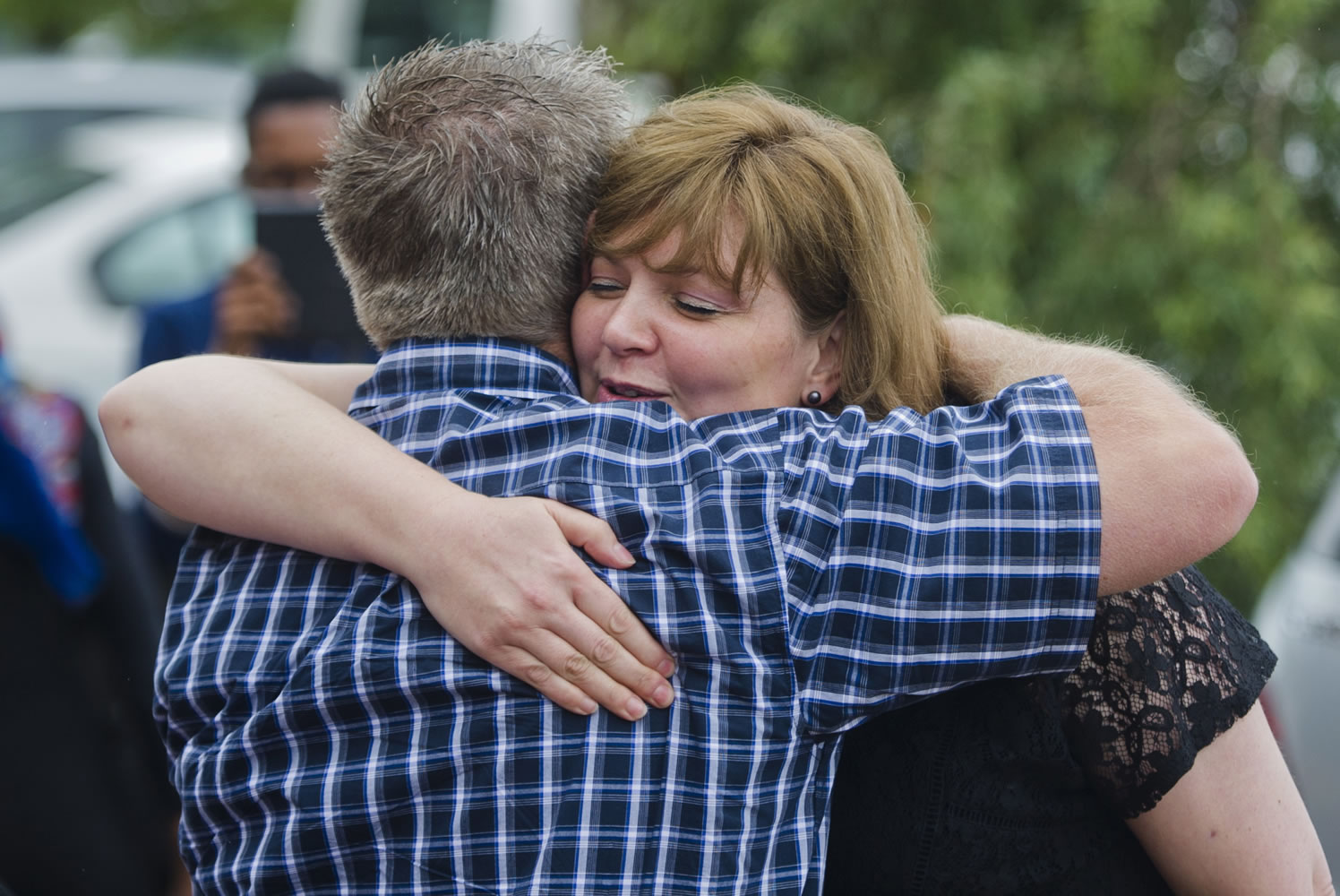 Associated Press
Hannelie Groenewald, the wife of slain aid worker Werner Groenewald, is comforted Friday after a memorial service in Pretoria, South Africa. Werner Groenewald and his teenage children were killed Nov. 29 in Kabul, Afghanistan.