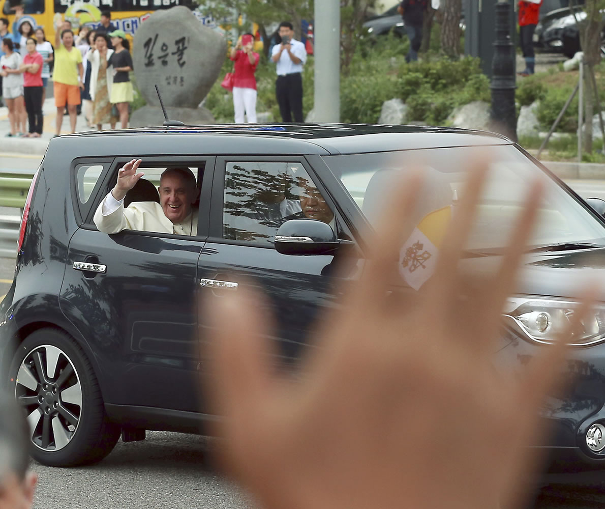Pope Francis waves from a car Thursday in Seongnam, South Korea.