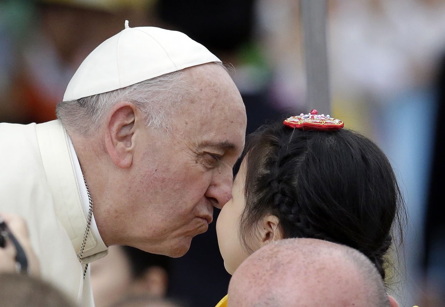 Pope Francis, kisses a child upon arrival Sunday for the Closing Holy Mass of the 6th Asian Youth Day at Haemi Castle in Haemi, south of Seoul, South Korea.