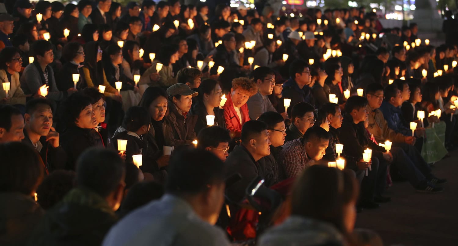 South Koreans hold candles during a prayer for people believed to have been trapped in the sunken ferry Sewol, in Ansan, South Korea, on Monday.