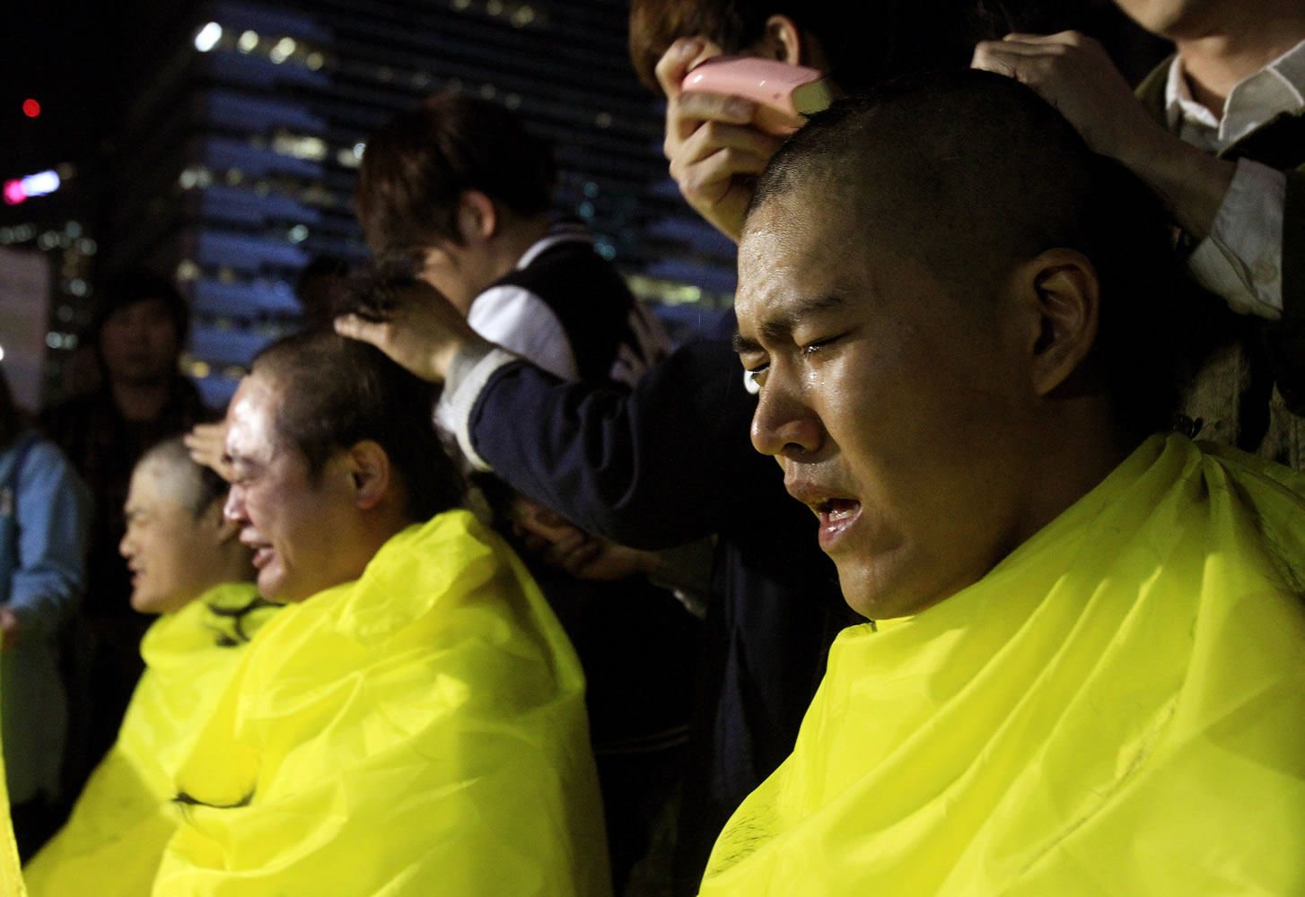 College students have their heads shaved during a rally to call for thorough investigations into the sunken ferry Sewol in Seoul, South Korea, on Thursday.