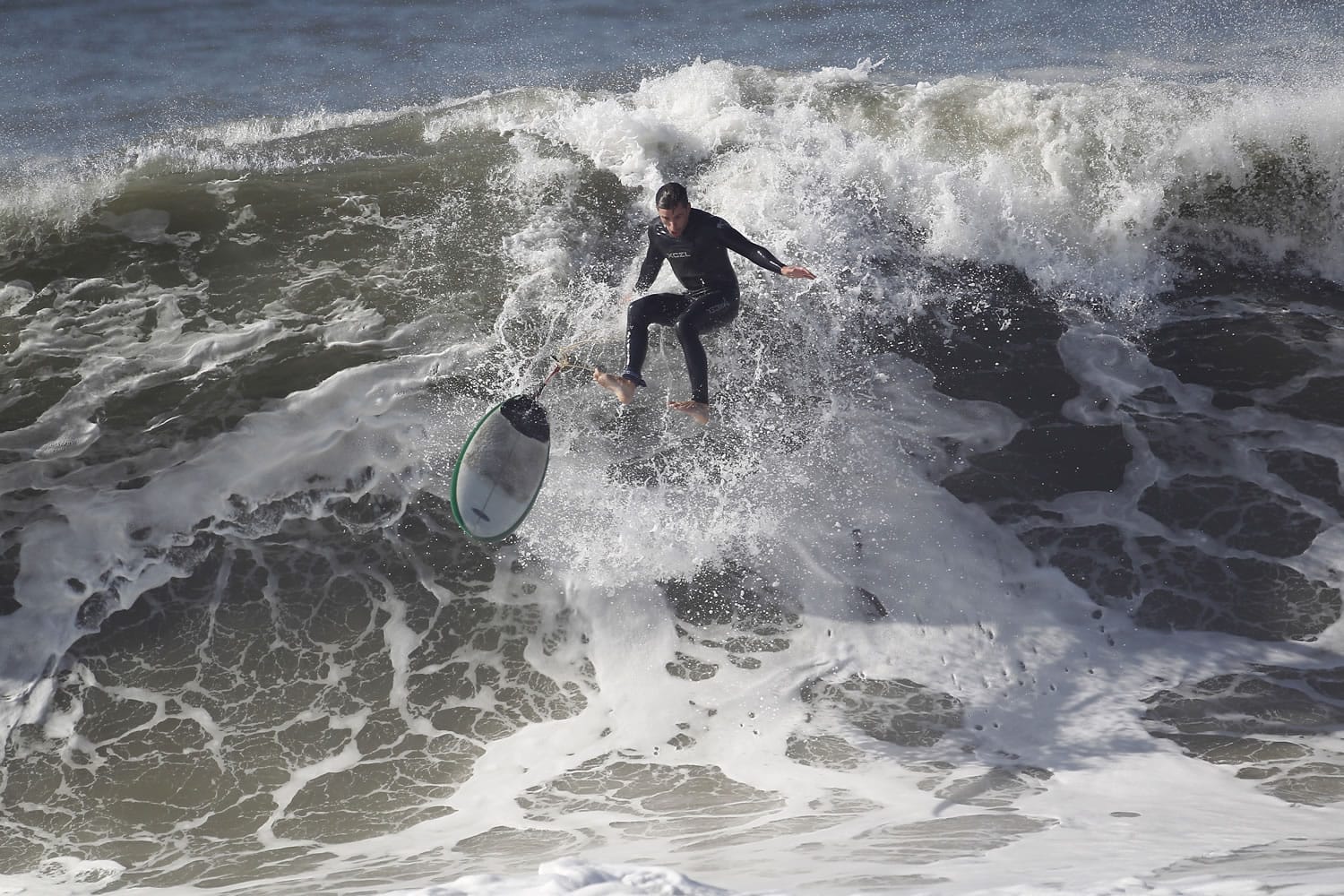 Nick Ut/Associated Press
A surfer wipes out from a large wave at Seal Beach on Wednesday. The National Weather Service said beaches stretching 100 miles up the Southern California coast would see large waves and rip currents.