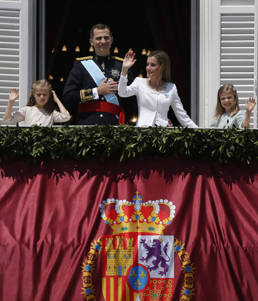 Spain's newly crowned King Felipe VI and his wife, Queen Letizia, wave to the crowd with their daughters Princess Sofia, right, and Princess Leonor on Thursday from the Royal Palace in Madrid, Spain.