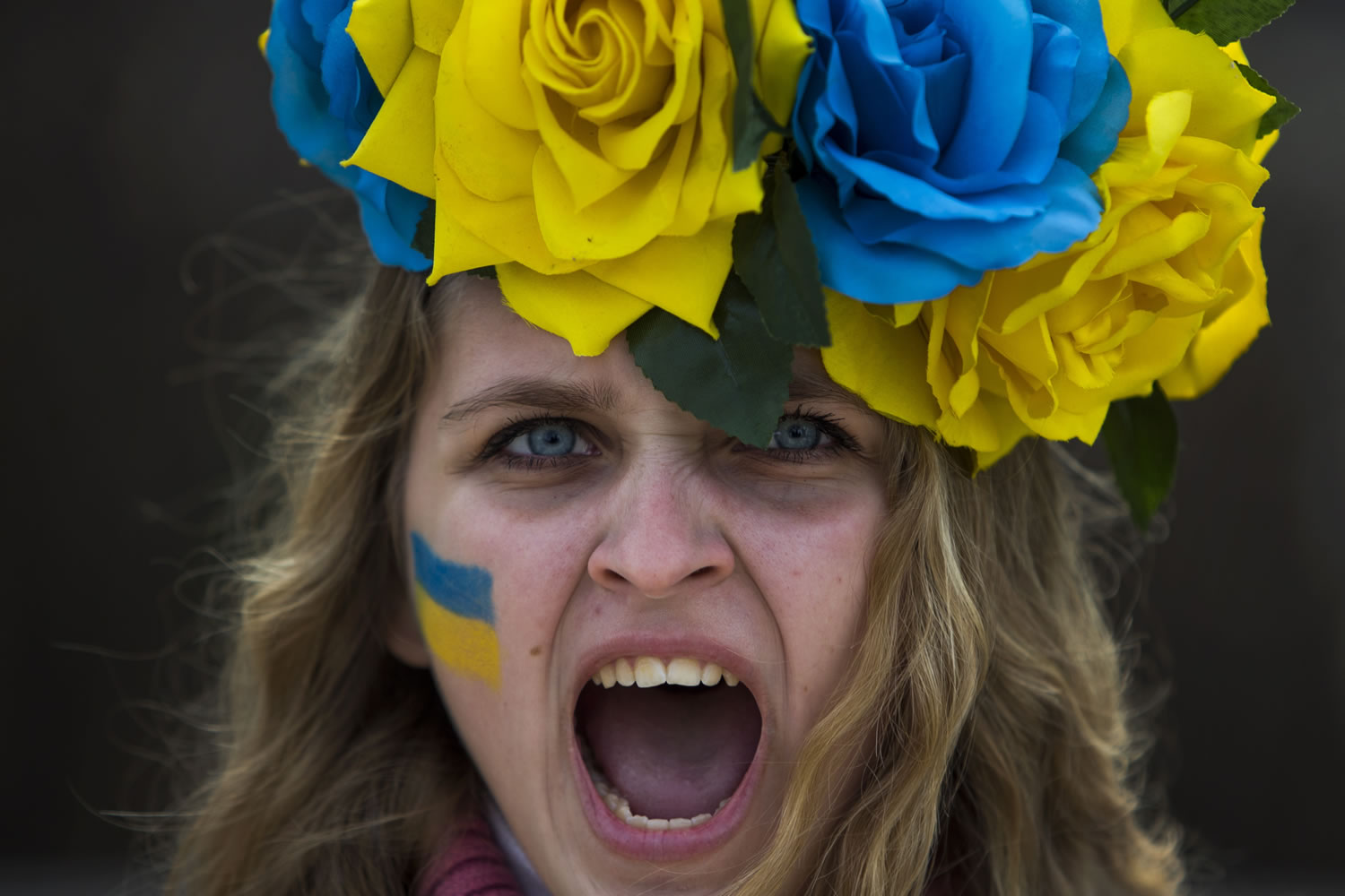 A protestor shouts slogans during a demonstration in support of Ukraine's protests against Viktor Yanukovych's government in Madrid, Spain, Sunday, Jan. 26, 2014. The protests began in late November in Ukraine after President Viktor Yanukovych shelved a long-awaited agreement to deepen ties with the European Union, but they have been increasingly gripped by people seeking more radical action even as moderate opposition leaders have pleaded for a stop to violence. In the past week, demonstrators have seized government administration buildings in a score of cities in western Ukraine, where Yanukovych's support is weak and desire for European ties is strong.