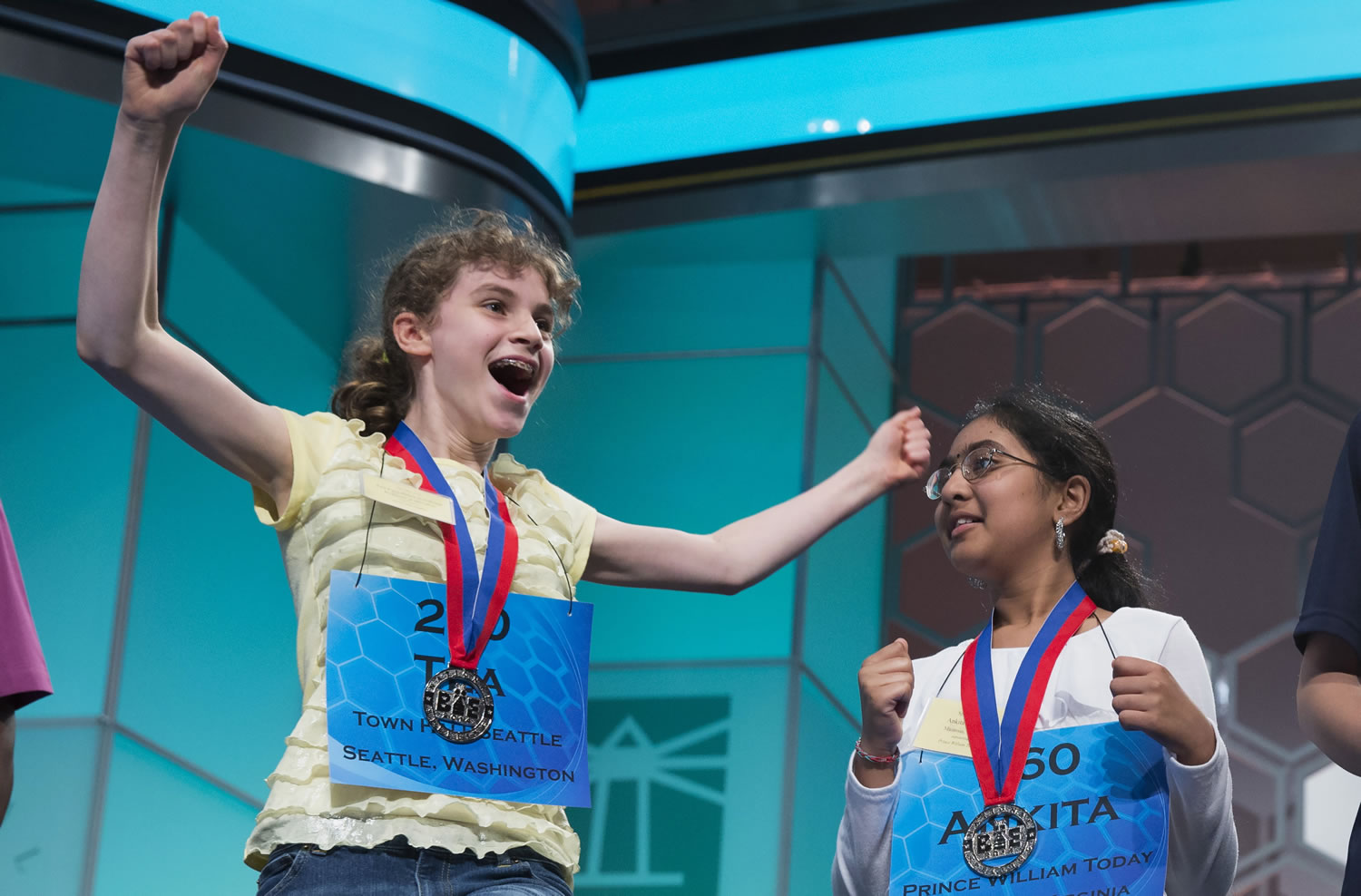 Tea Freedman-Susskind of Redmond, left, and Ankita Vadiala of Manassas, Va., qualify for the semifinal round of the National Spelling Bee in Oxon Hill, Md.
