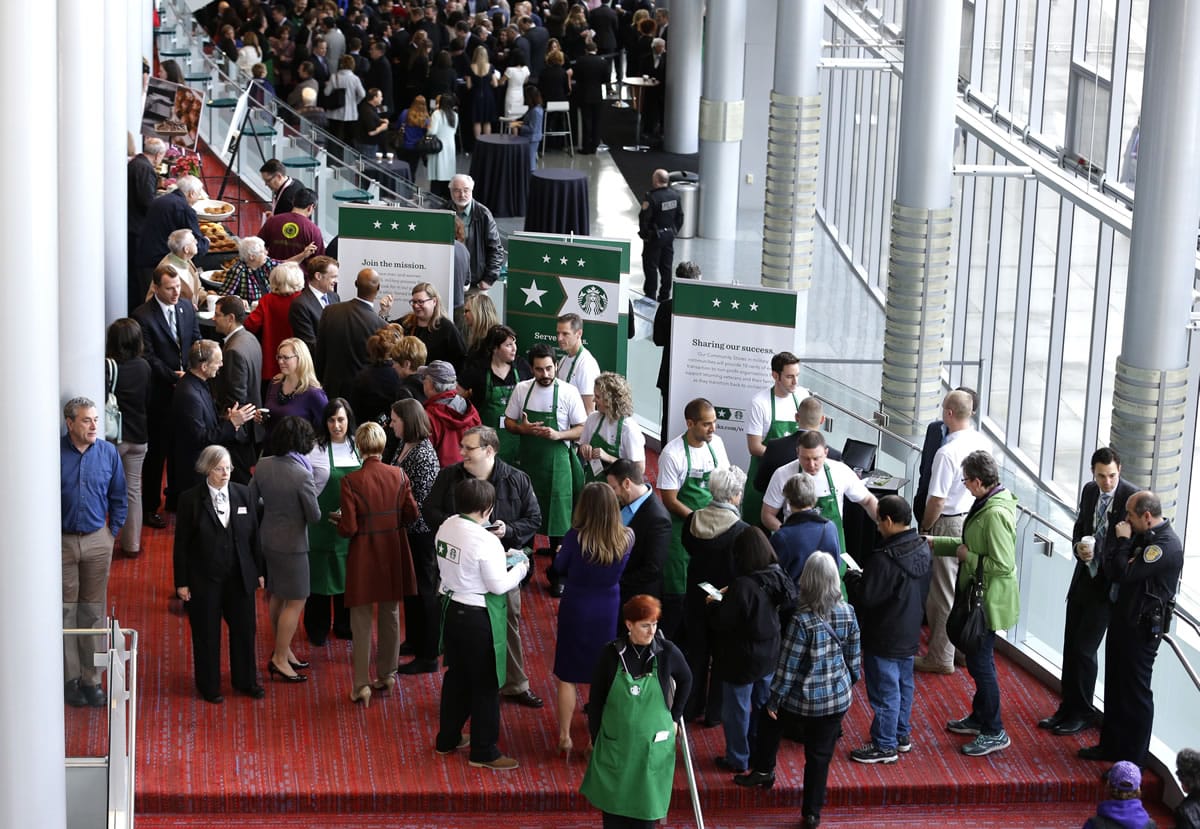 Shareholders and other guests arrive for the annual Starbucks Coffee Company shareholders meeting Wednesday in Seattle.